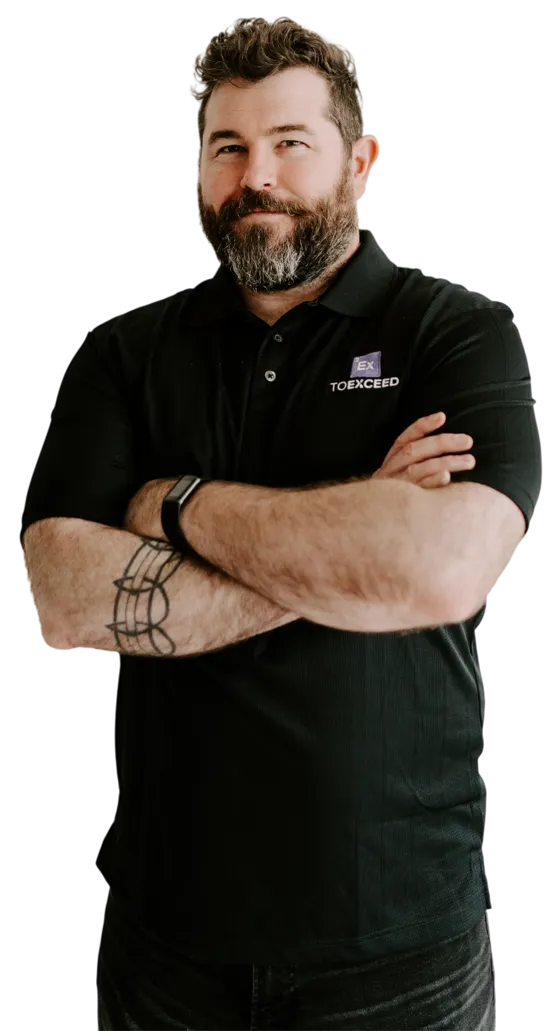 Matt from the To Exceed team, arms folded, wearing a To Exceed polo shirt