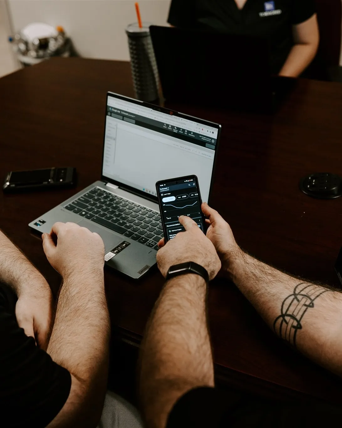 To Exceed team reviewing digital marketing reporting on a phone